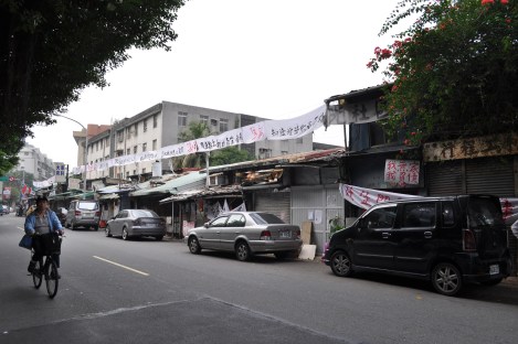 banners line the road telling taipei what is going on in huaguang. what used to be a row of shops now only has one beef noodles shop open for business/huaguang community, taipei/feb 3, 2013